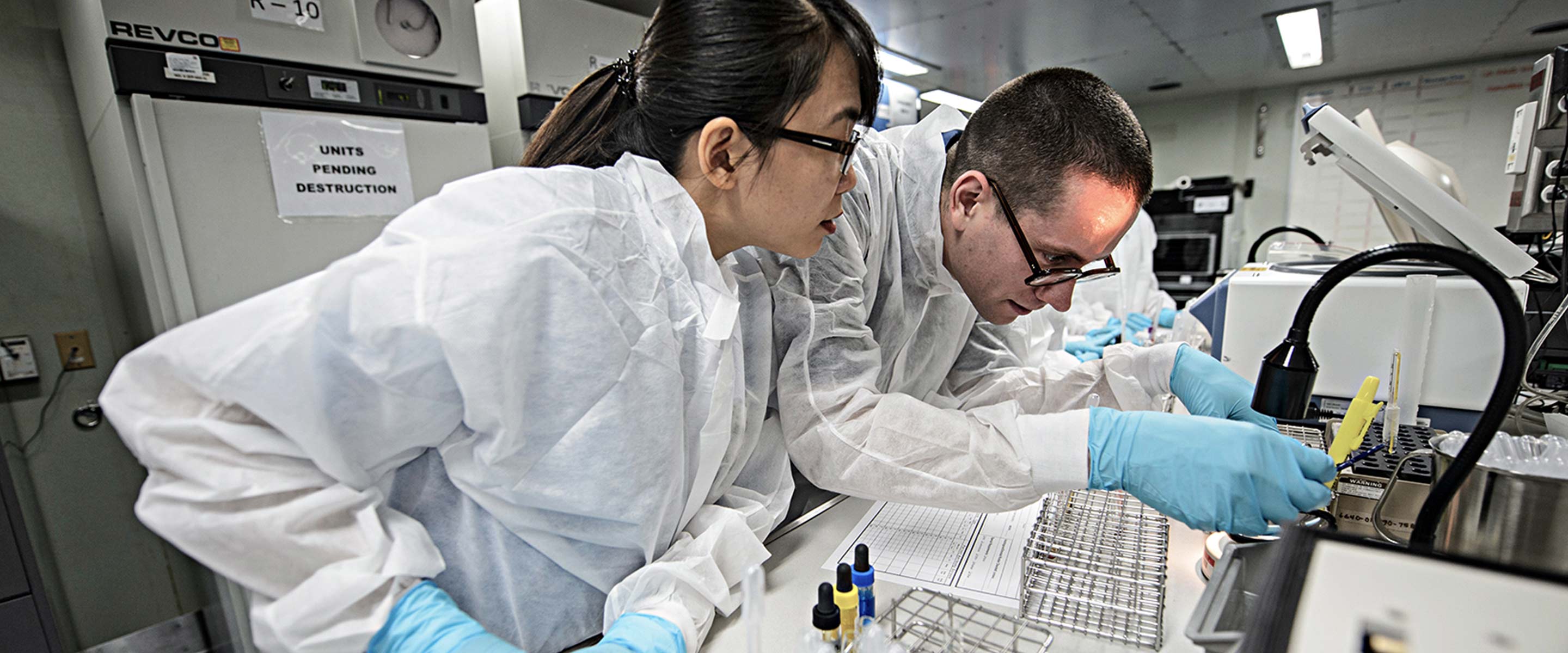 Two Navy biochemists work together in a laboratory
