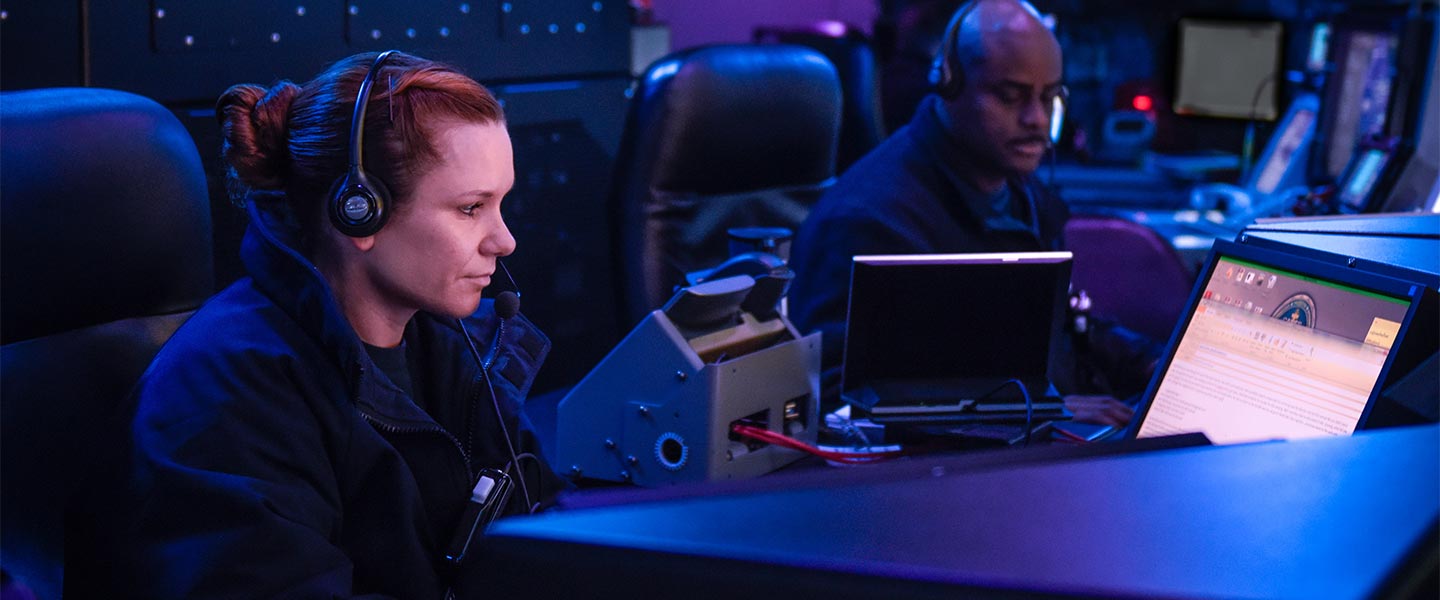 Intelligence Specialists work aboard a Navy ship