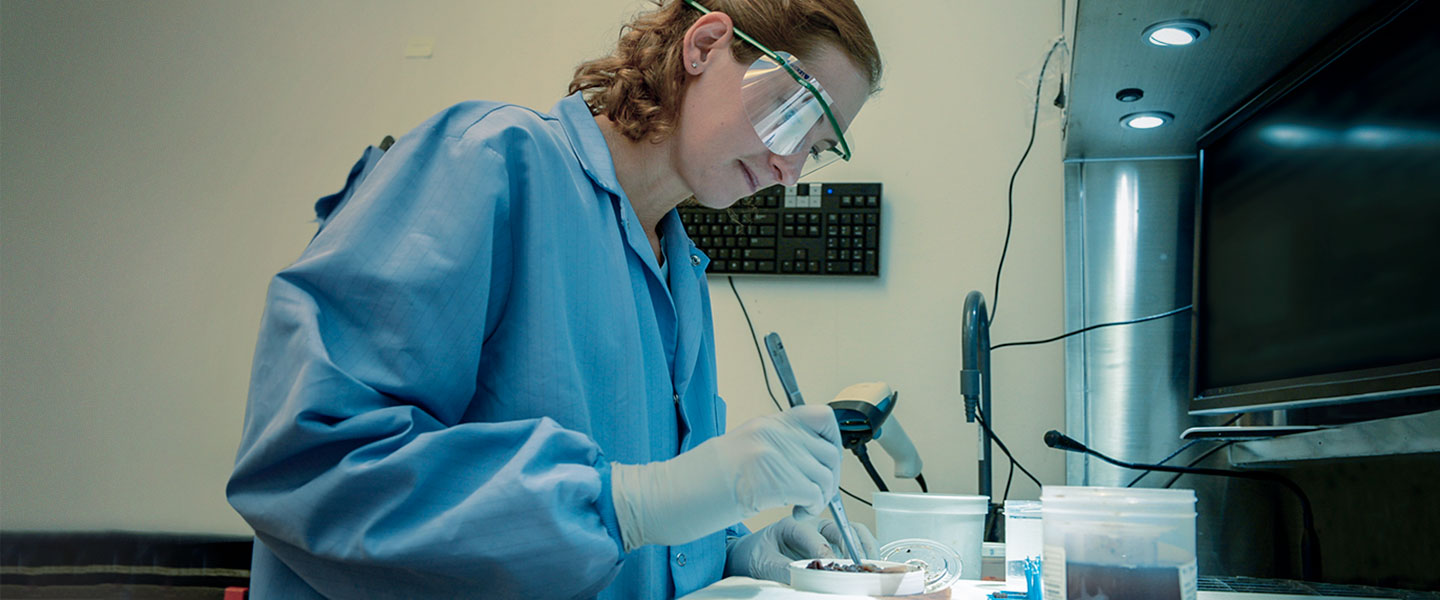 Navy Pathologist Heather Gaburo examines tissue in the lab at the Naval Medical Center in San Diego
