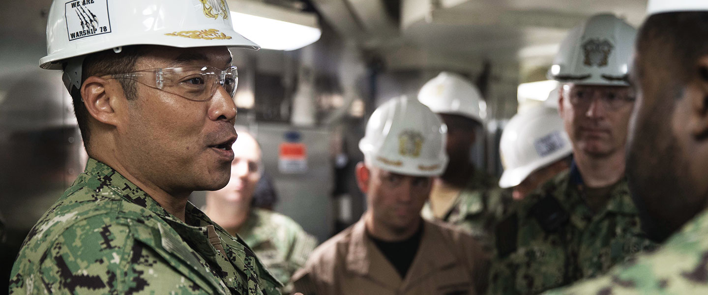 Rear Adm. Kenneth Epps, Deputy Chief of Staff for Fleet Ordnance and Supply/Fleet Supply Officer, U.S. Fleet Forces Command, receives a brief from Culinary Specialist 1st Class Charles Masten, from Philadelphia, assigned to USS Gerald R. Ford's supply department.