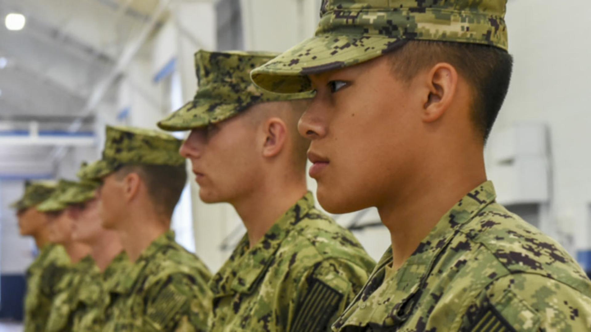 New Student Indoctrination midshipman candidates stand at attention inside Atlantic Fleet Drill Hall at Recruit Training Command (RTC) as part of NSI