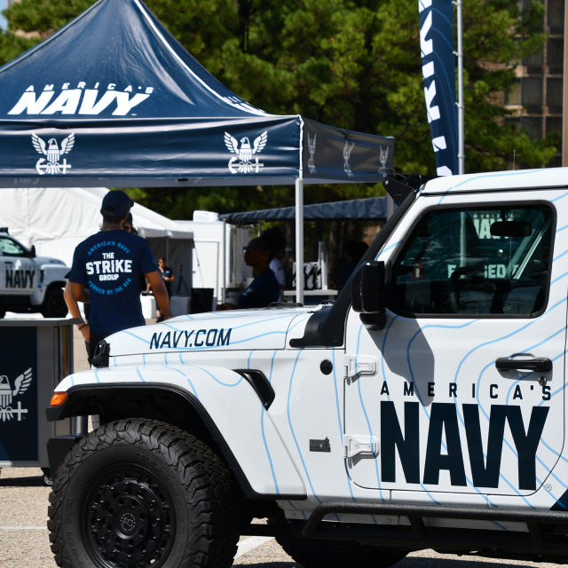 Vehicle and tent setup at The Strike Group experience, presented by America's Navy.