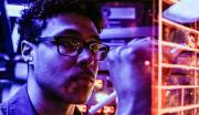 A United States Navy Cryptologic Technician works at a station aboard a ship.